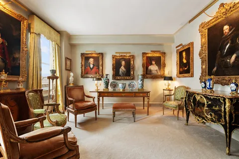a living room with furniture a flat screen tv and a window