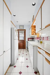 a kitchen with stainless steel appliances a refrigerator sink and cabinets