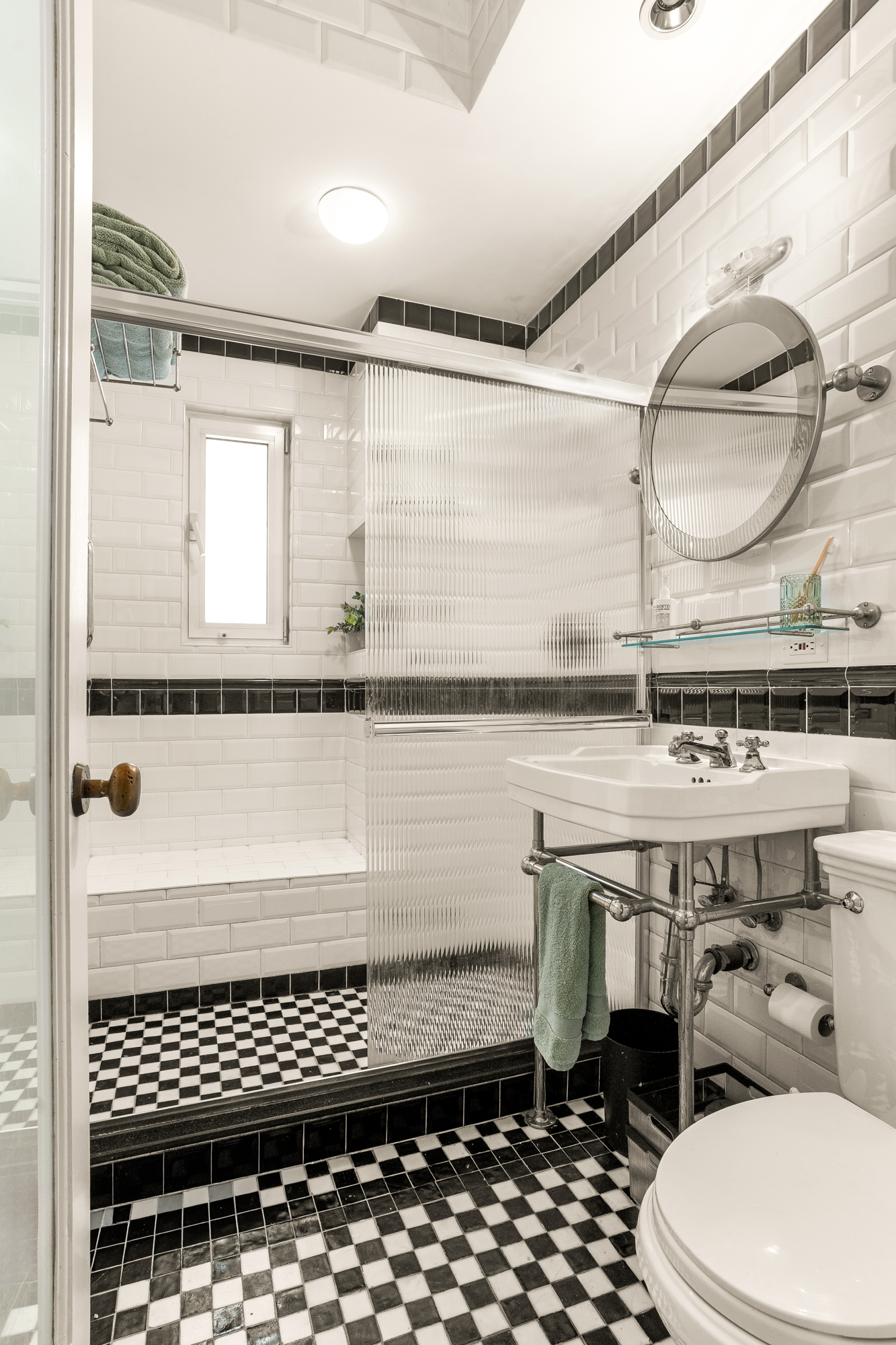 205 West 57th Street, Unit 11DB Manhattan, NY 10019 - Photo 8 of 10 a bathroom with a toilet a sink and a mirror