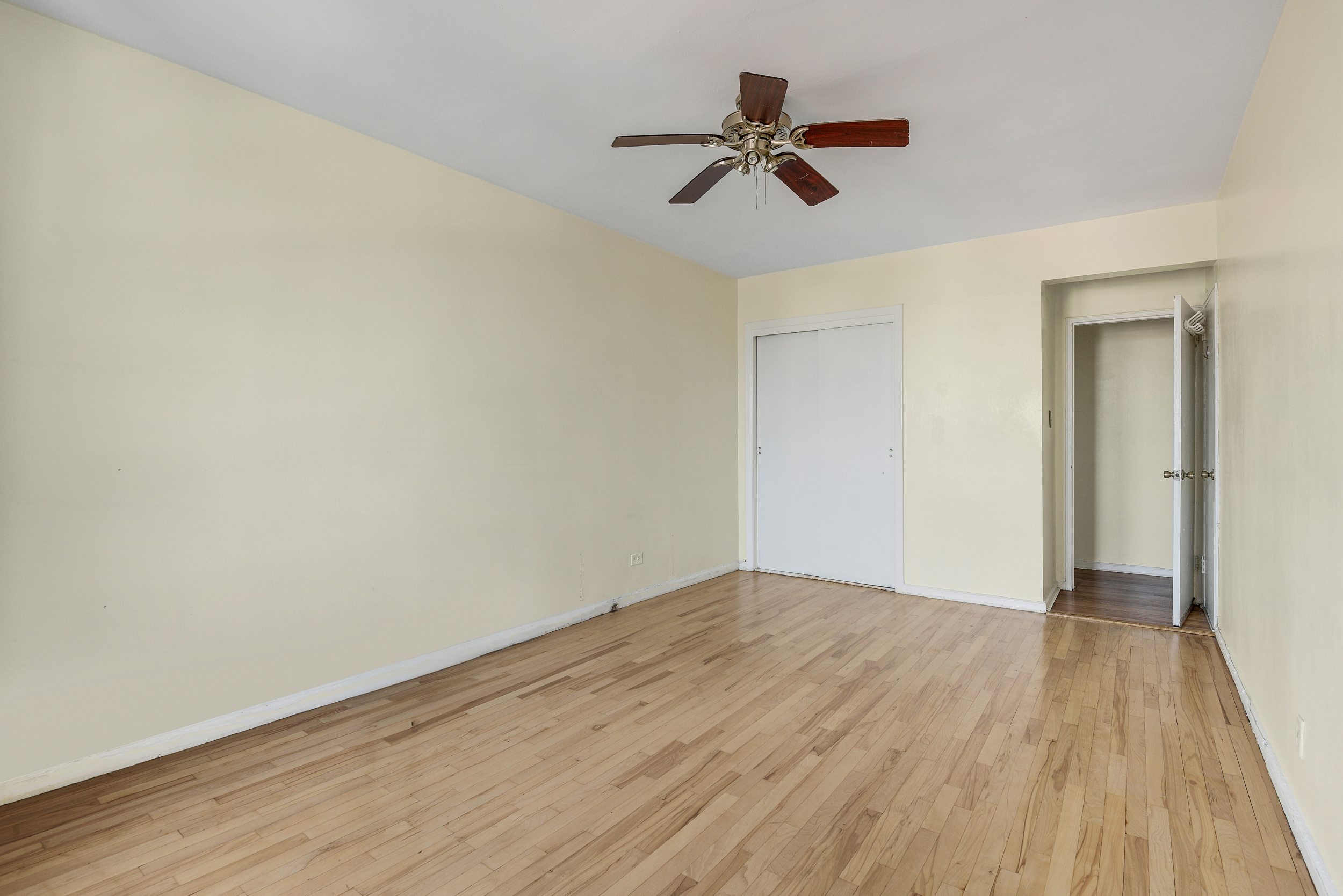 9801 Shore Road, Unit 4P Brooklyn, NY 11209 - Photo 10 of 13 a view of room with a ceiling fan and wooden floor
