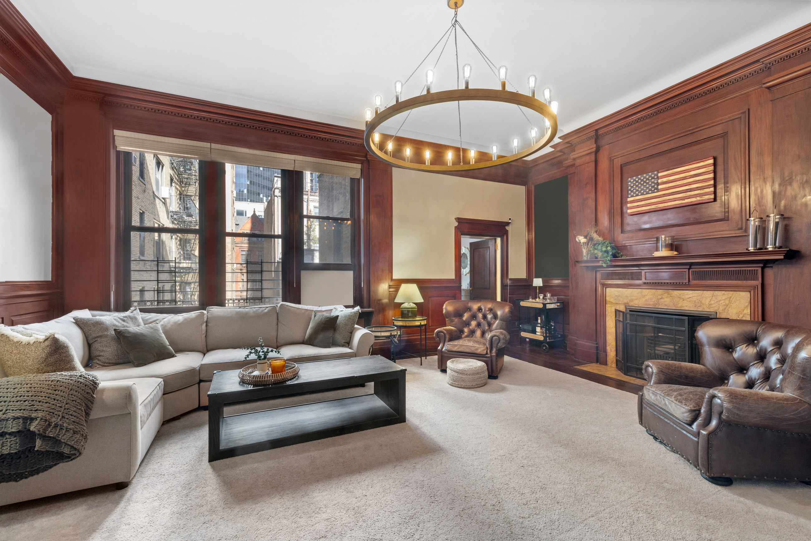 107 East 38th Street, Unit 2AB Manhattan, NY 10016 - Photo 11 of 13 a living room with furniture a fireplace and a chandelier