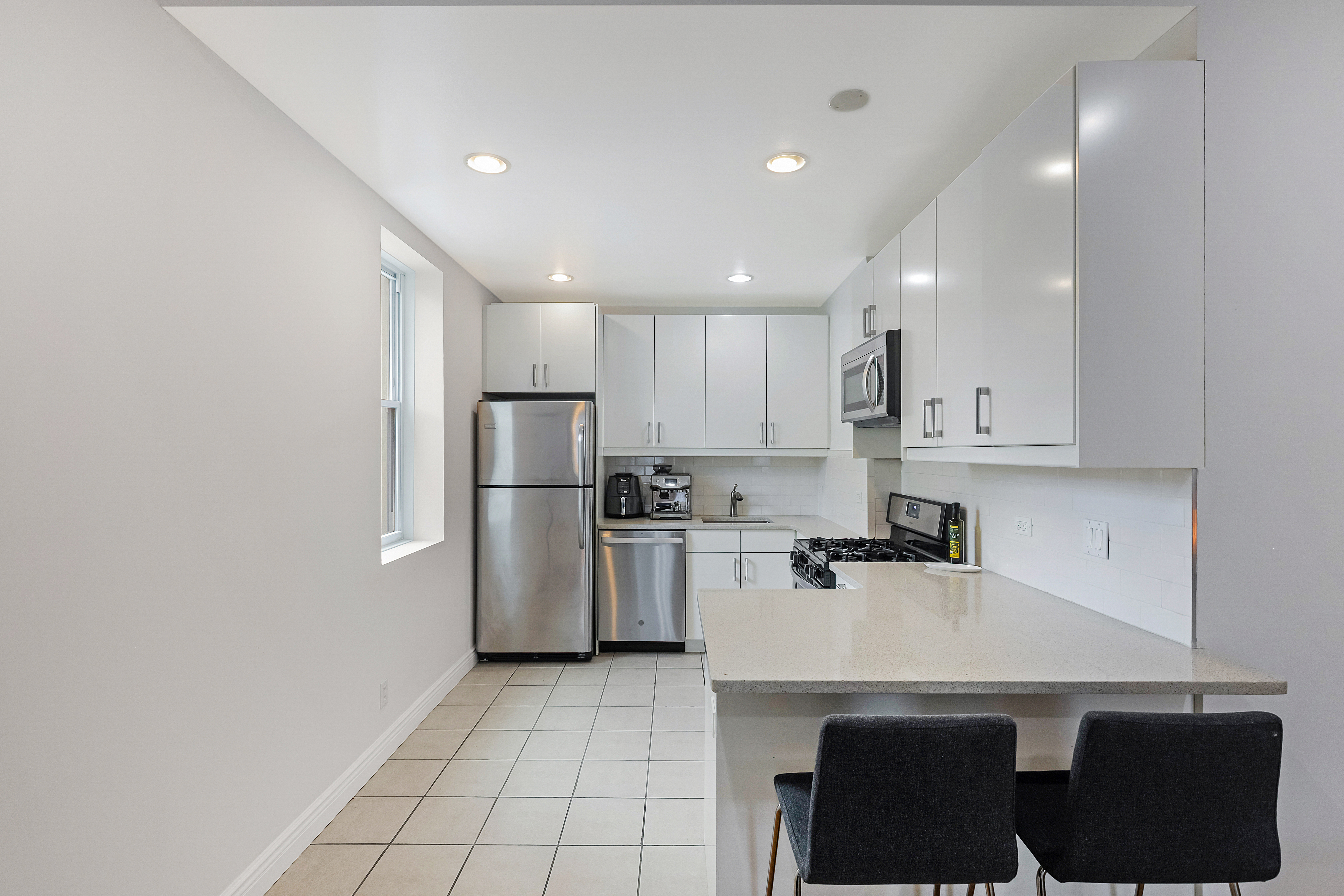 89 Wyckoff Street, Unit 4B Brooklyn, NY 11201 - Photo 2 of 9 a kitchen with a sink a refrigerator and cabinets