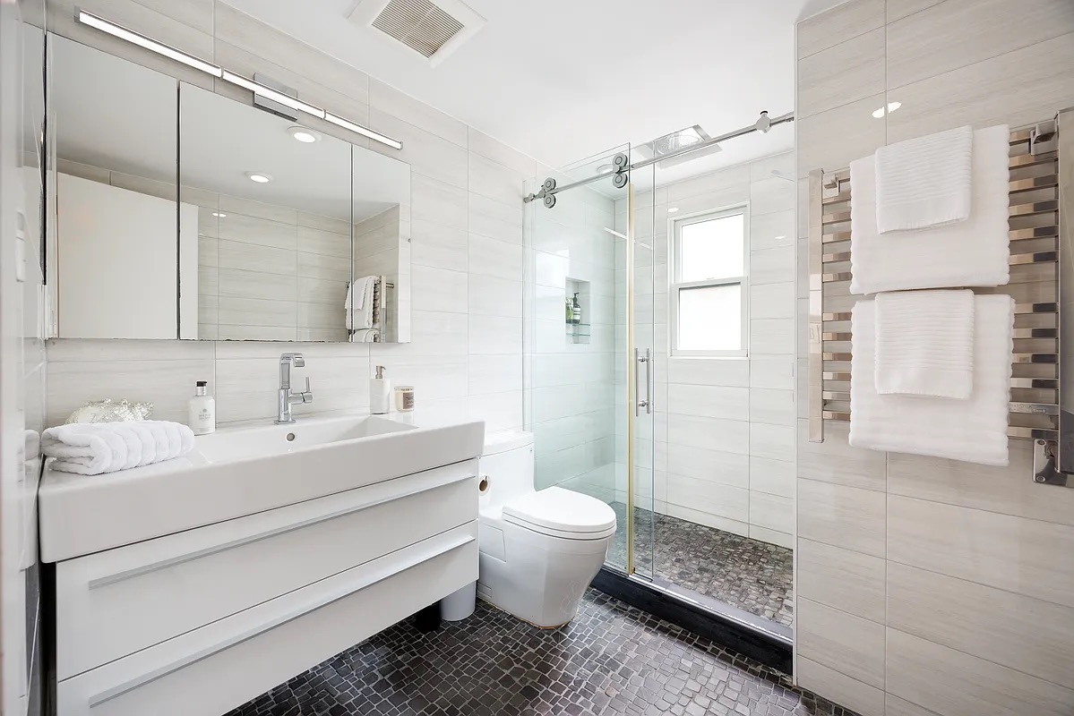 158 President Street, Unit 1 Brooklyn, NY 11231 - Photo 7 of 10 a bathroom with a sink toilet double vanity and shower