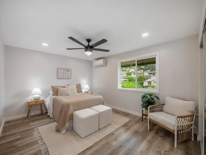 a living room with a bed furniture and a window