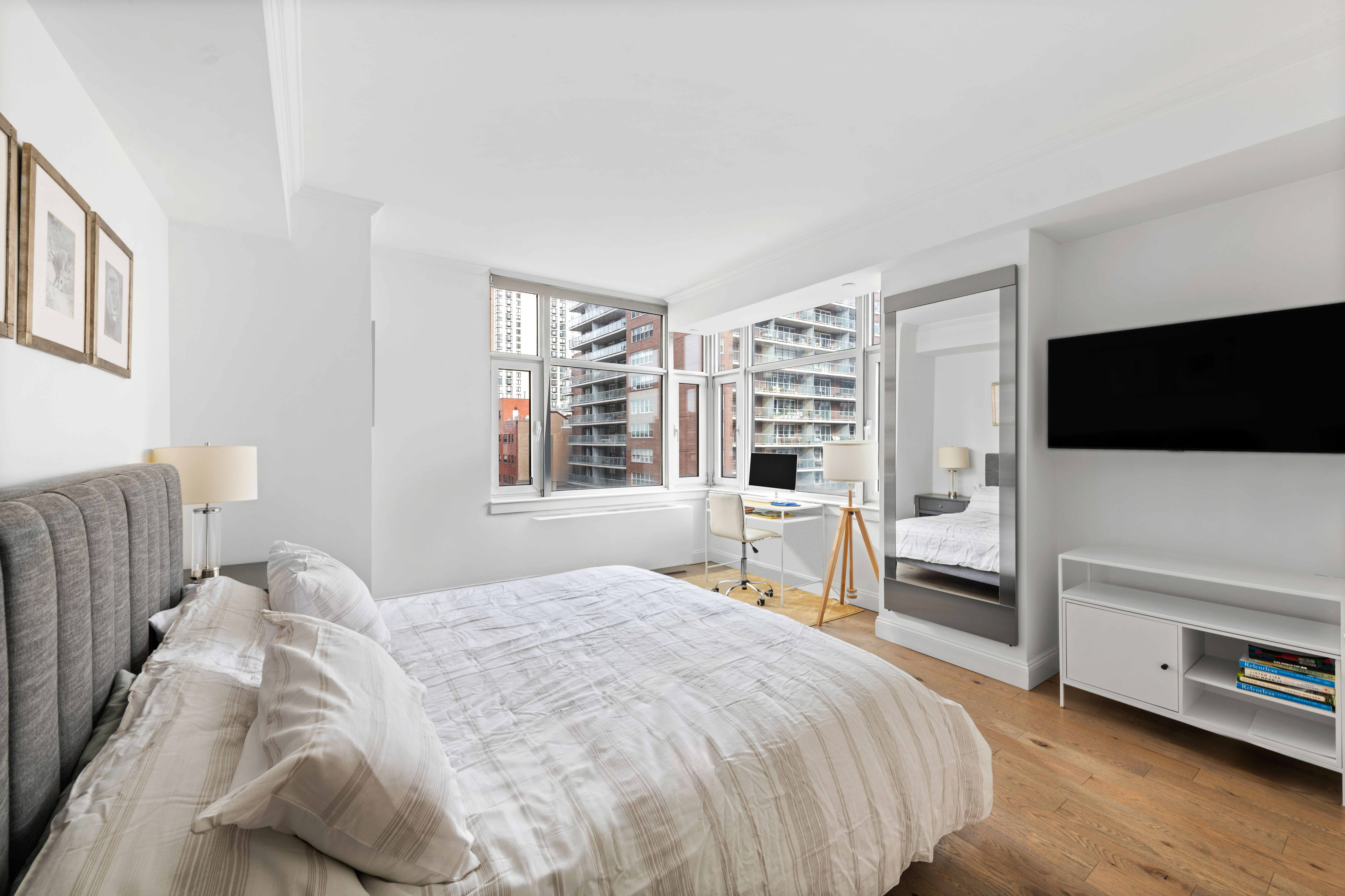 404 East 76th Street, Unit 8A Manhattan, NY 10021 - Photo 6 of 17 a bedroom with a bed and a flat screen tv