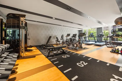 a room with gym equipment and large mirror