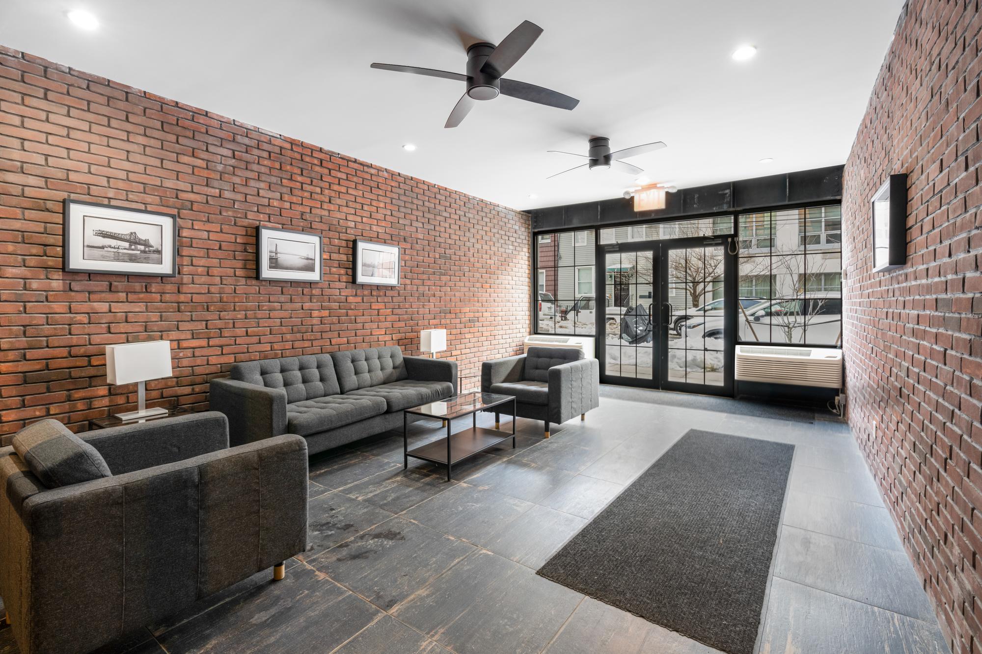 5-25 47th Road, Unit 2A Queens, NY 11101 - Photo 15 of 17 a living room with furniture and a fireplace