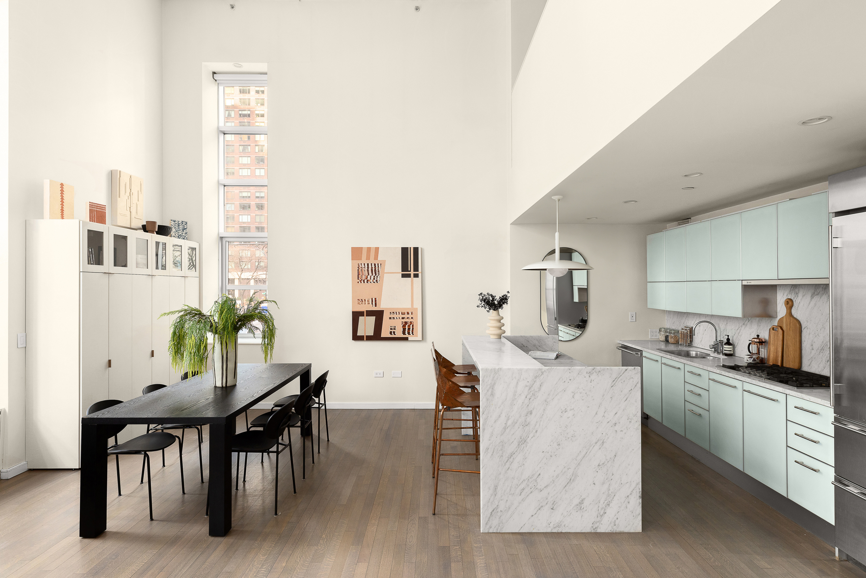 310 East 53rd Street, Unit 2/3D Manhattan, NY 10022 - Photo 5 of 13 a living room with furniture and a kitchen area