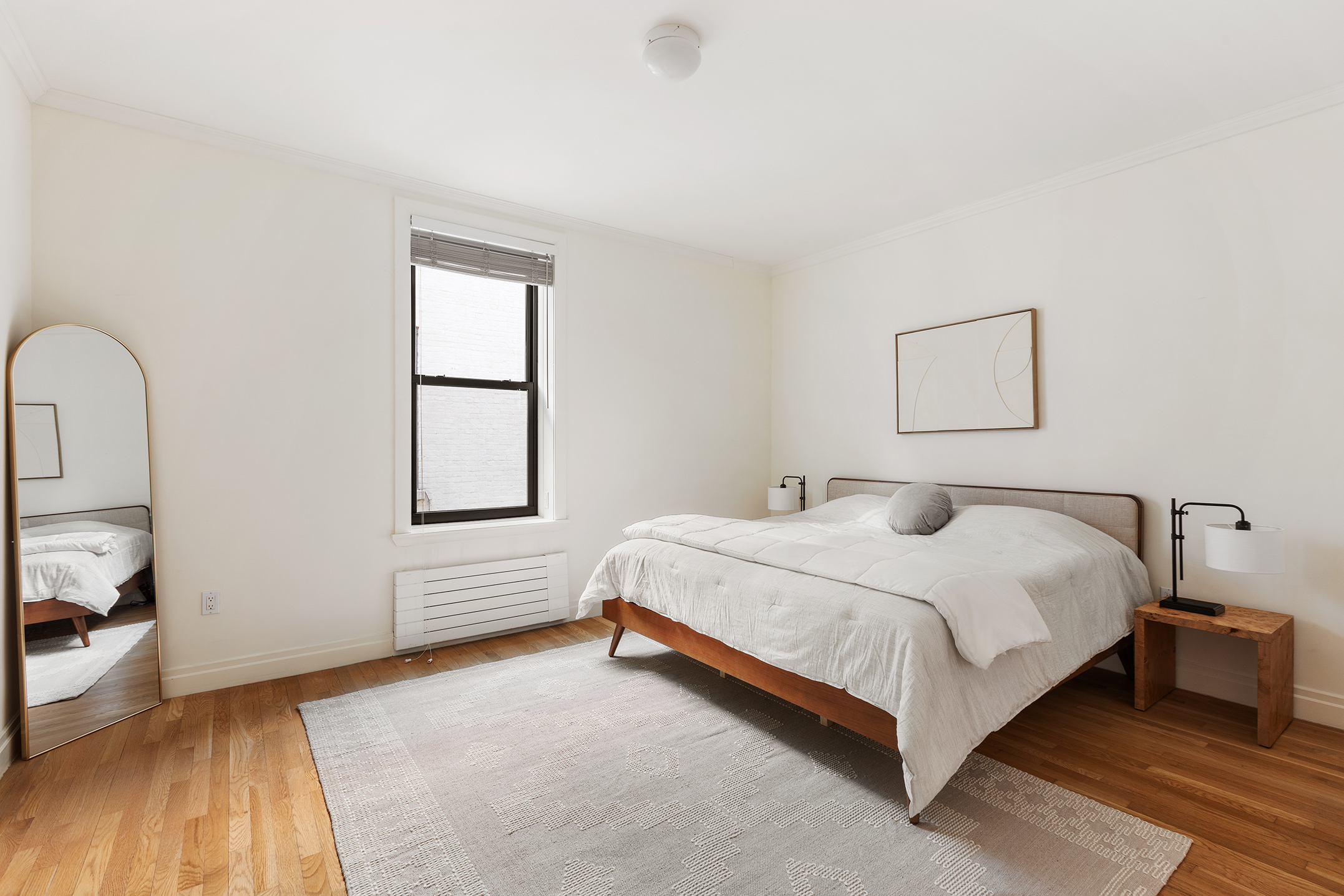 1845 Adam Clayton Powell Jr Boulevard, Unit 5C Manhattan, NY 10026 - Photo 9 of 17 a bedroom with a bed and a large window