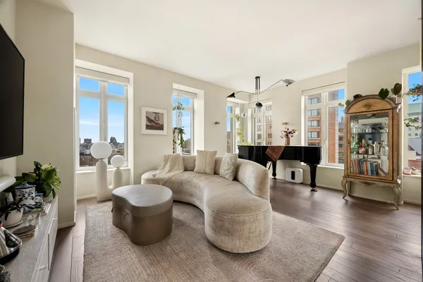 a living room with furniture and wooden floor