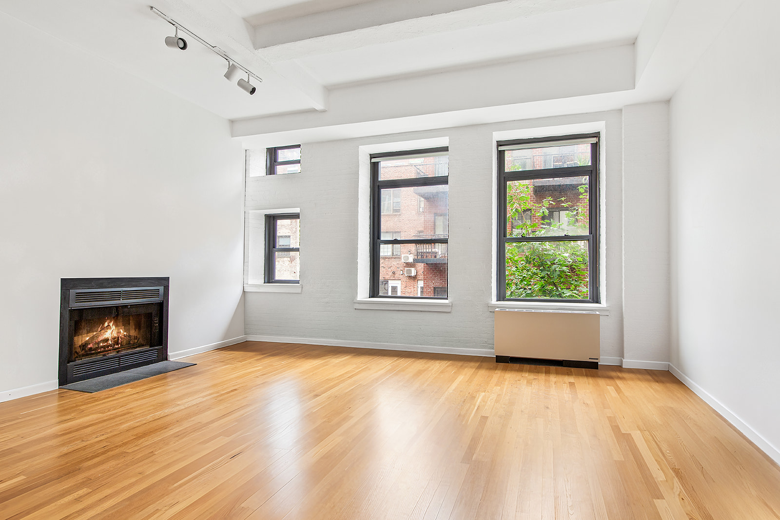 321 West 13th Street, Unit 3A Manhattan, NY 10014 - Photo 8 of 12 a view of an empty room with window and fire place