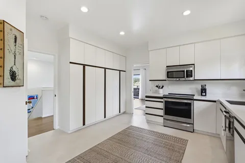 a kitchen with stainless steel appliances cabinets and a counter top space