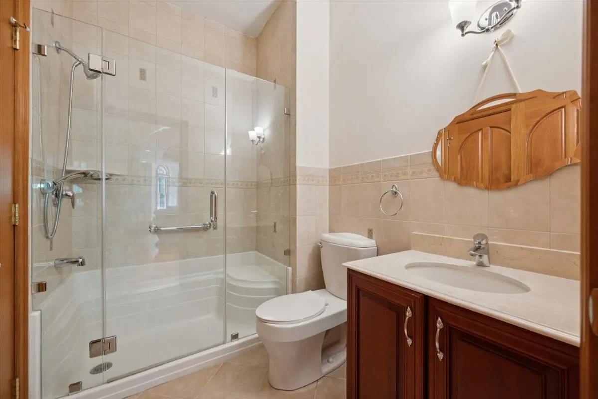 a kitchen with stainless steel appliances granite countertop a stove top oven a sink dishwasher a dining table and chairs with wooden floor