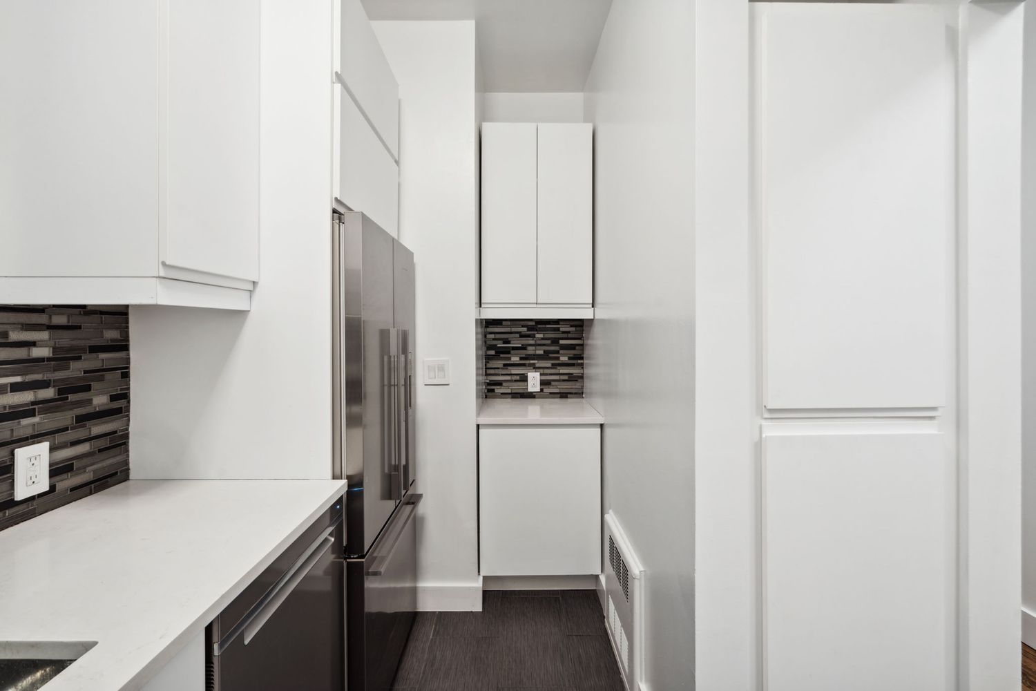 a kitchen with a refrigerator and a stove