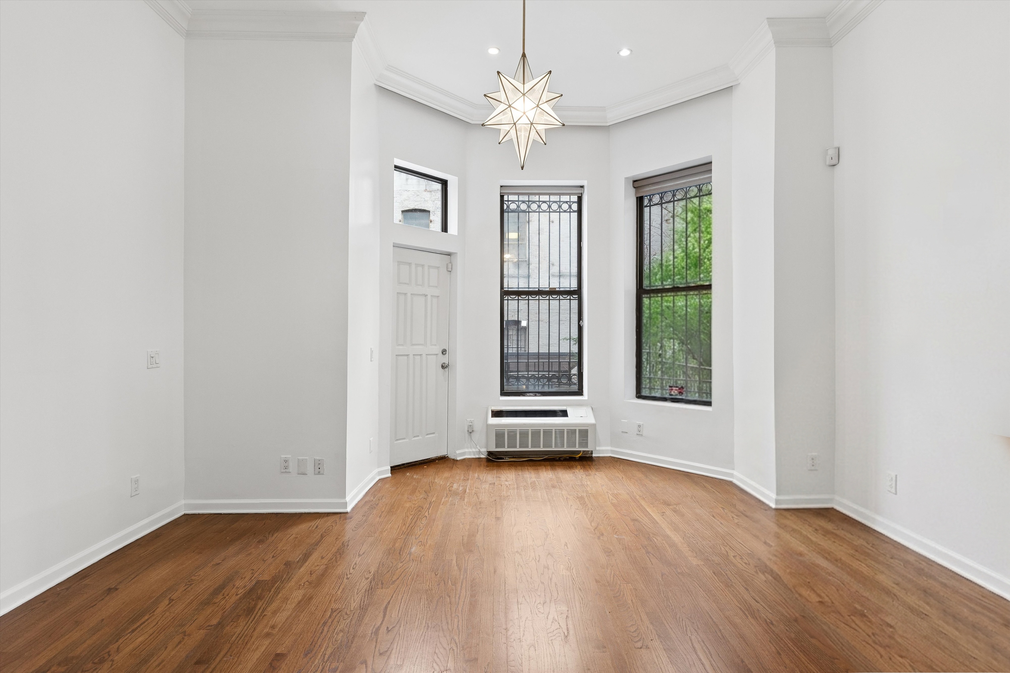 165 West 126th Street Manhattan, NY 10027 - Photo 13 of 40 wooden floor in an empty room with a window