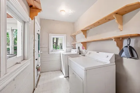 a bedroom with a bed and a flat tv screen on dresser