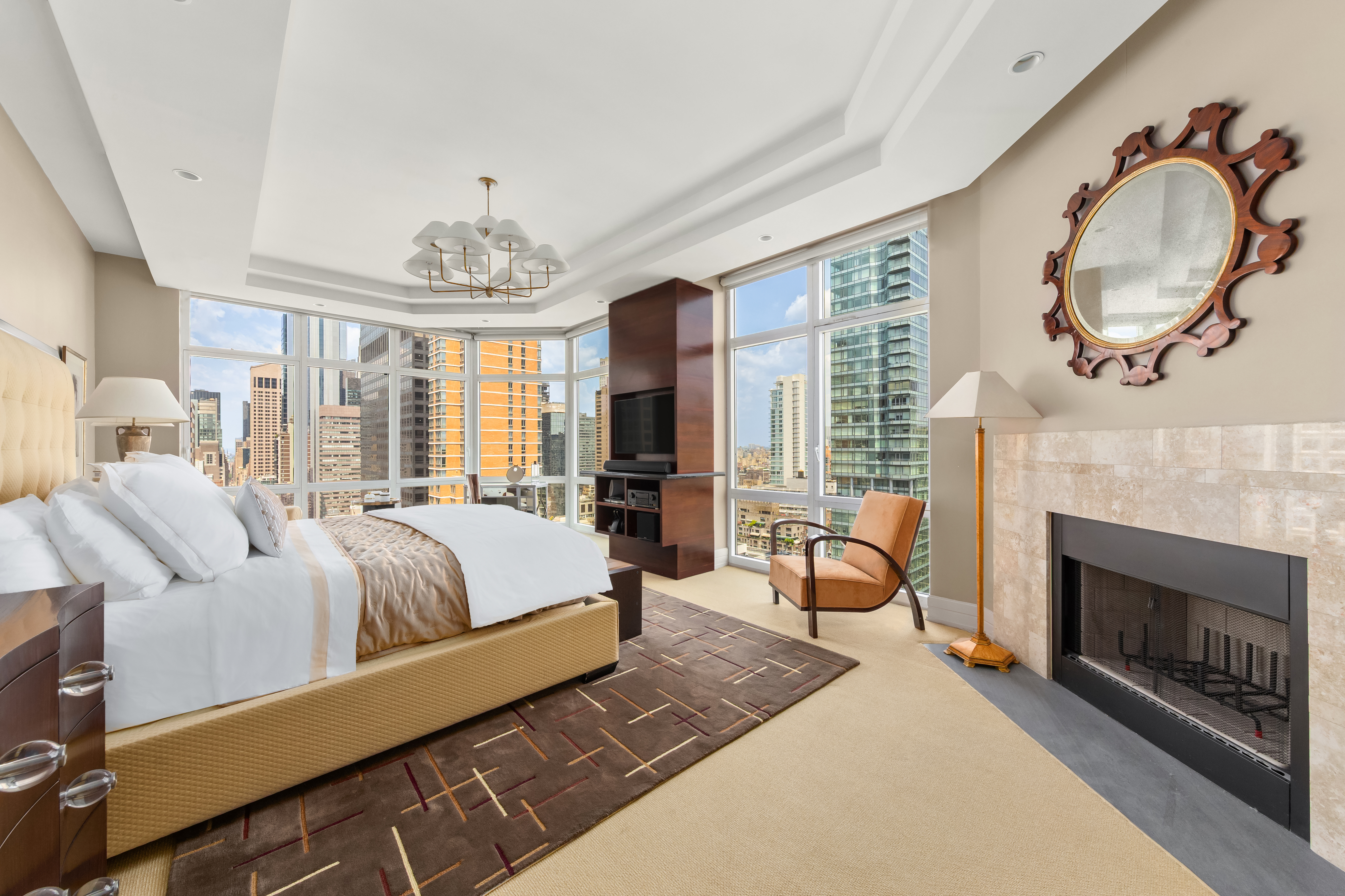 300 East 55th Street, Unit PHC Manhattan, NY 10022 - Photo 9 of 21 a living room with furniture a fireplace and a chandelier