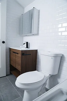 143-86 232nd Street, Unit 1 Queens, NY 11413 - Photo 3 of 5 a bathroom with a toilet a sink and bathtub