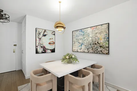 a view of a dining room with furniture and chandelier