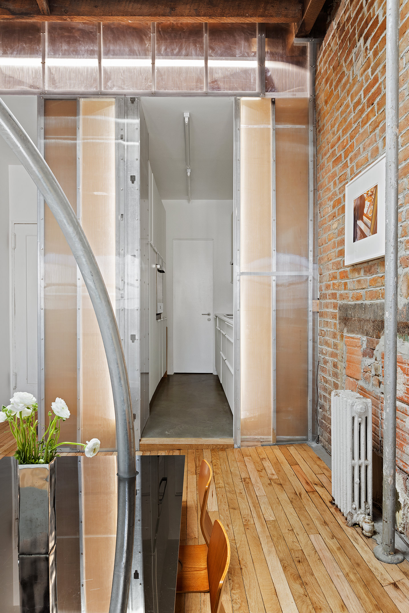 186 East 2nd Street, Unit 16 Manhattan, NY 10009 - Photo 6 of 17 a view of a hallway with wooden floor and staircase