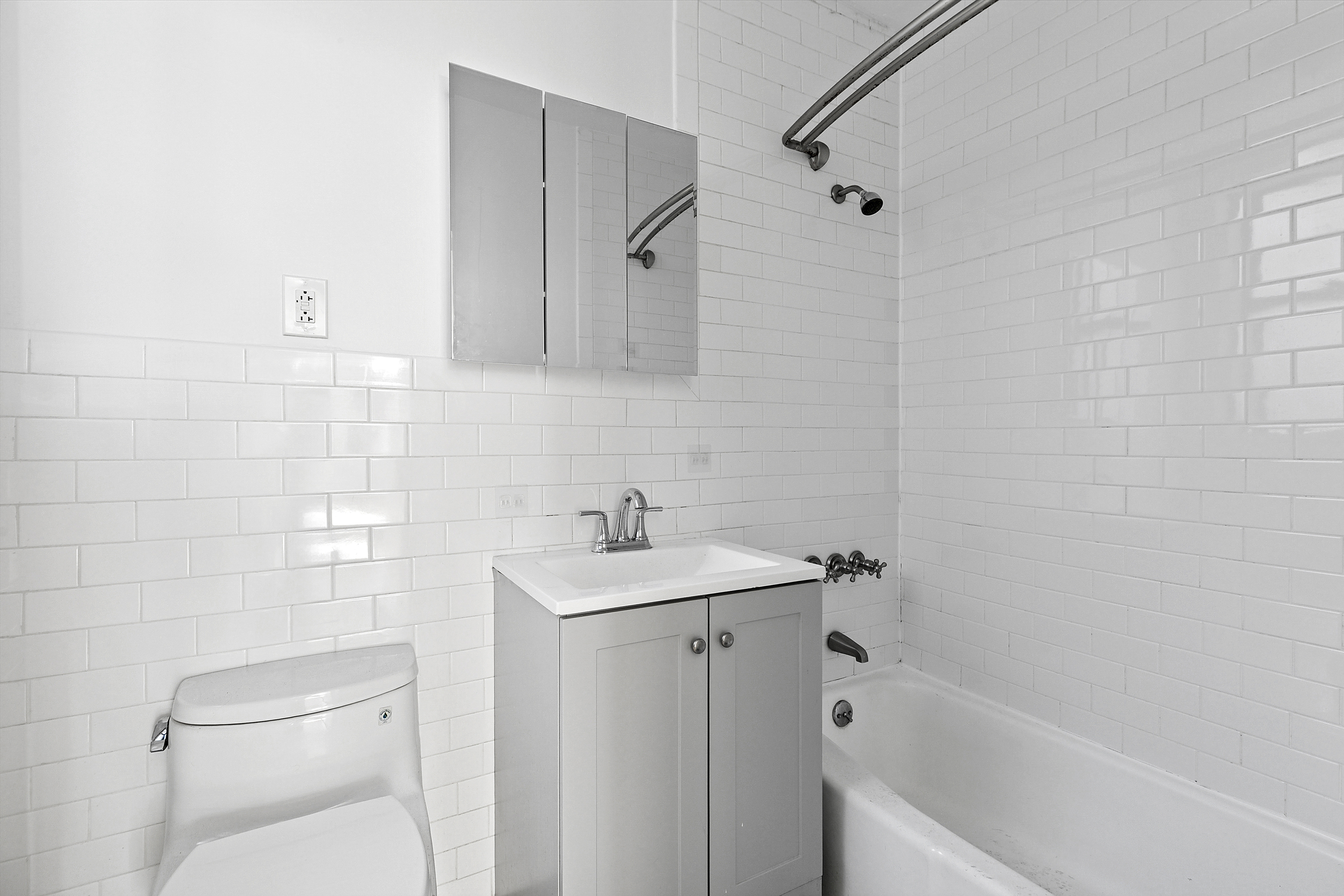 643 9th Avenue, Unit 4A Manhattan, NY 10036 - Photo 5 of 5 a bathroom with a sink a toilet and shower