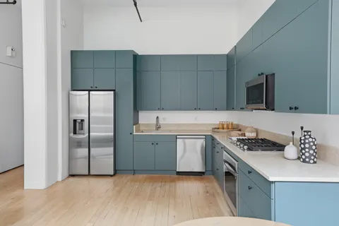 a kitchen with a sink appliances and cabinets