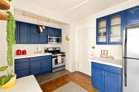 a kitchen with granite countertop wooden cabinets and stainless steel appliances