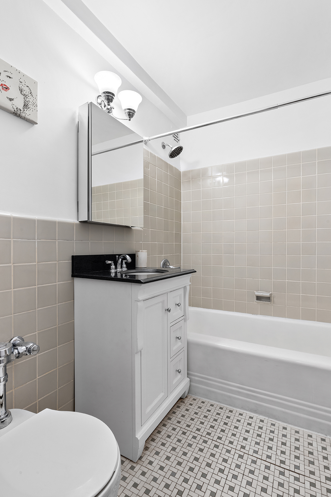 7 Lexington Avenue, Unit 9F Manhattan, NY 10010 - Photo 5 of 8 a bathroom with a sink a toilet and shower