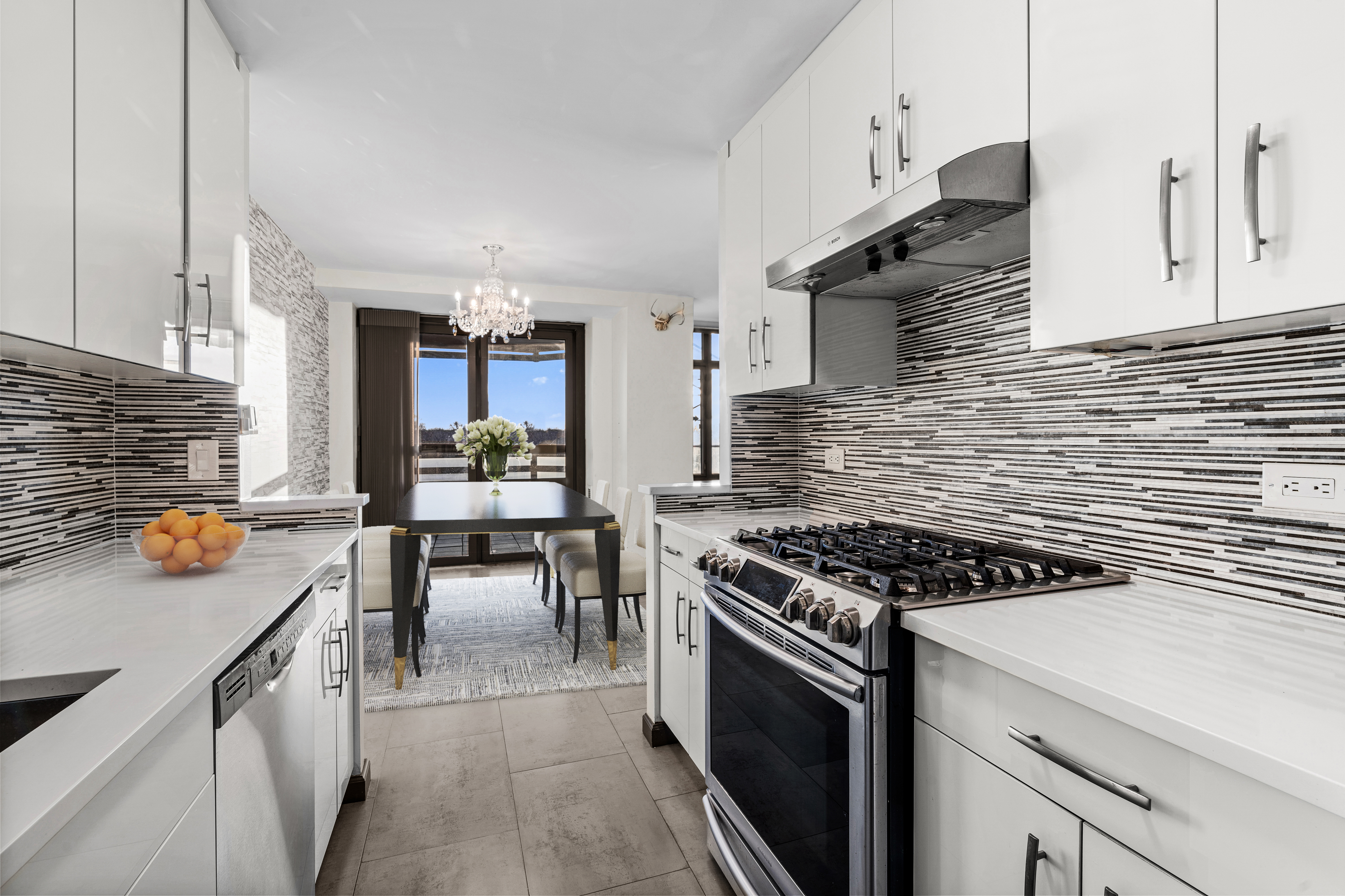 a kitchen with stainless steel appliances a stove a sink and cabinets