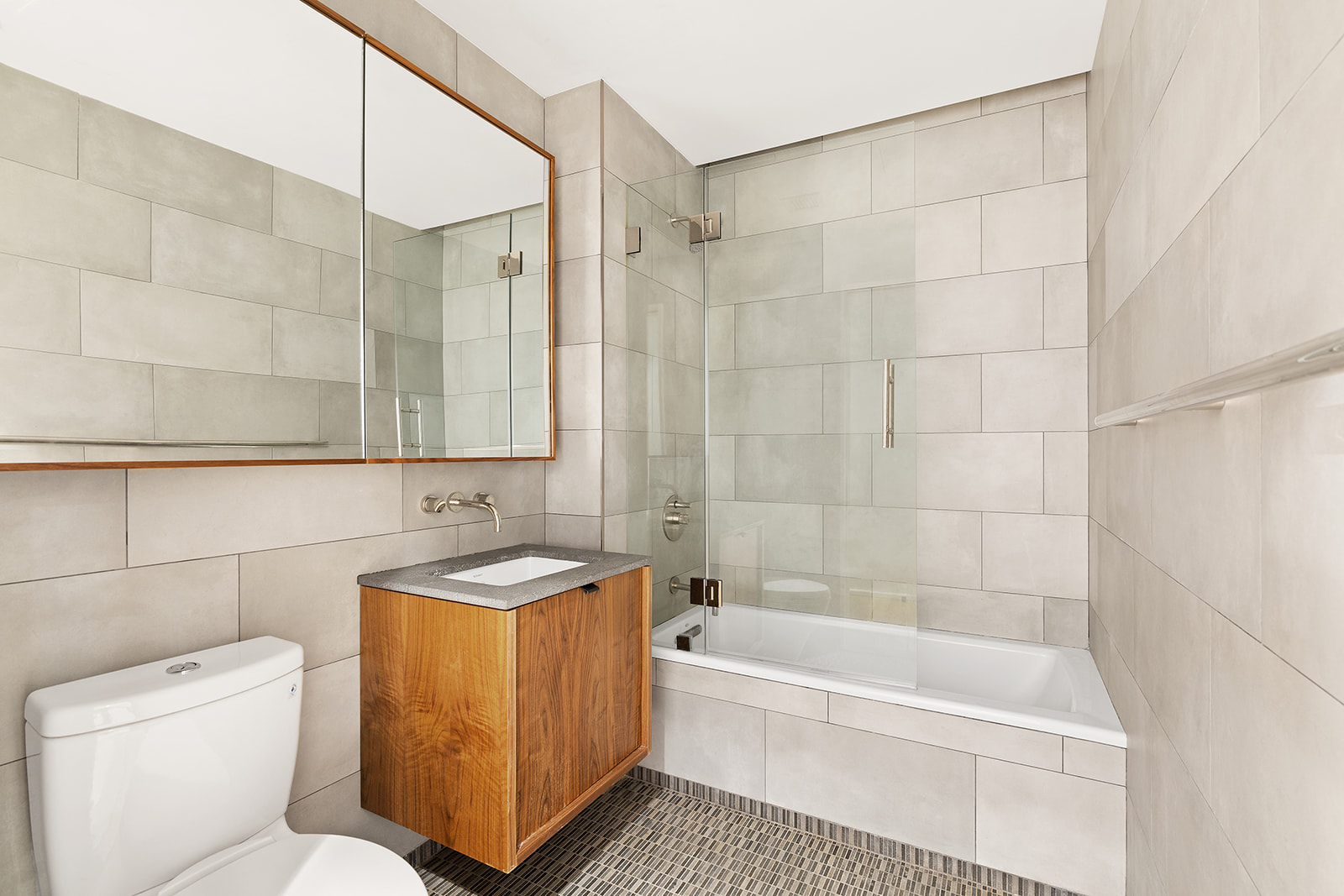 318 West 52nd Street, Unit 3N Manhattan, NY 10019 - Photo 7 of 9 a bathroom with a sink a toilet and bathtub