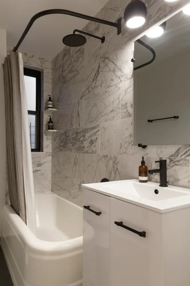 a bathroom with a sink a mirror and a bathtub