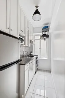 a kitchen with a sink a stove and cabinets