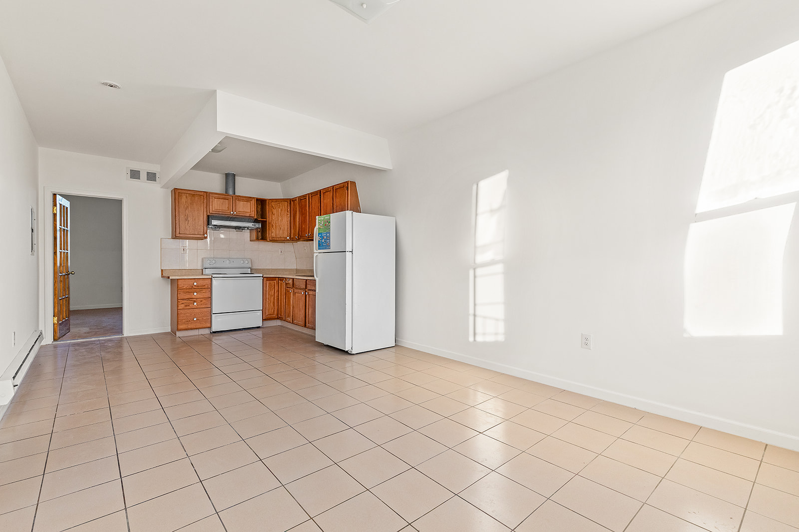 1644 Atlantic Avenue Brooklyn, NY 11213 - Photo 8 of 17 a view of a kitchen with furniture and a refrigerator