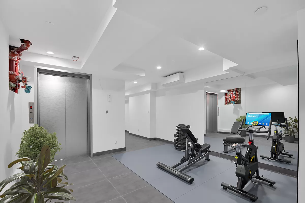 145 West 129th Street, Unit 3 Manhattan, NY 10027 - Photo 9 of 11 a view of a room with gym equipment