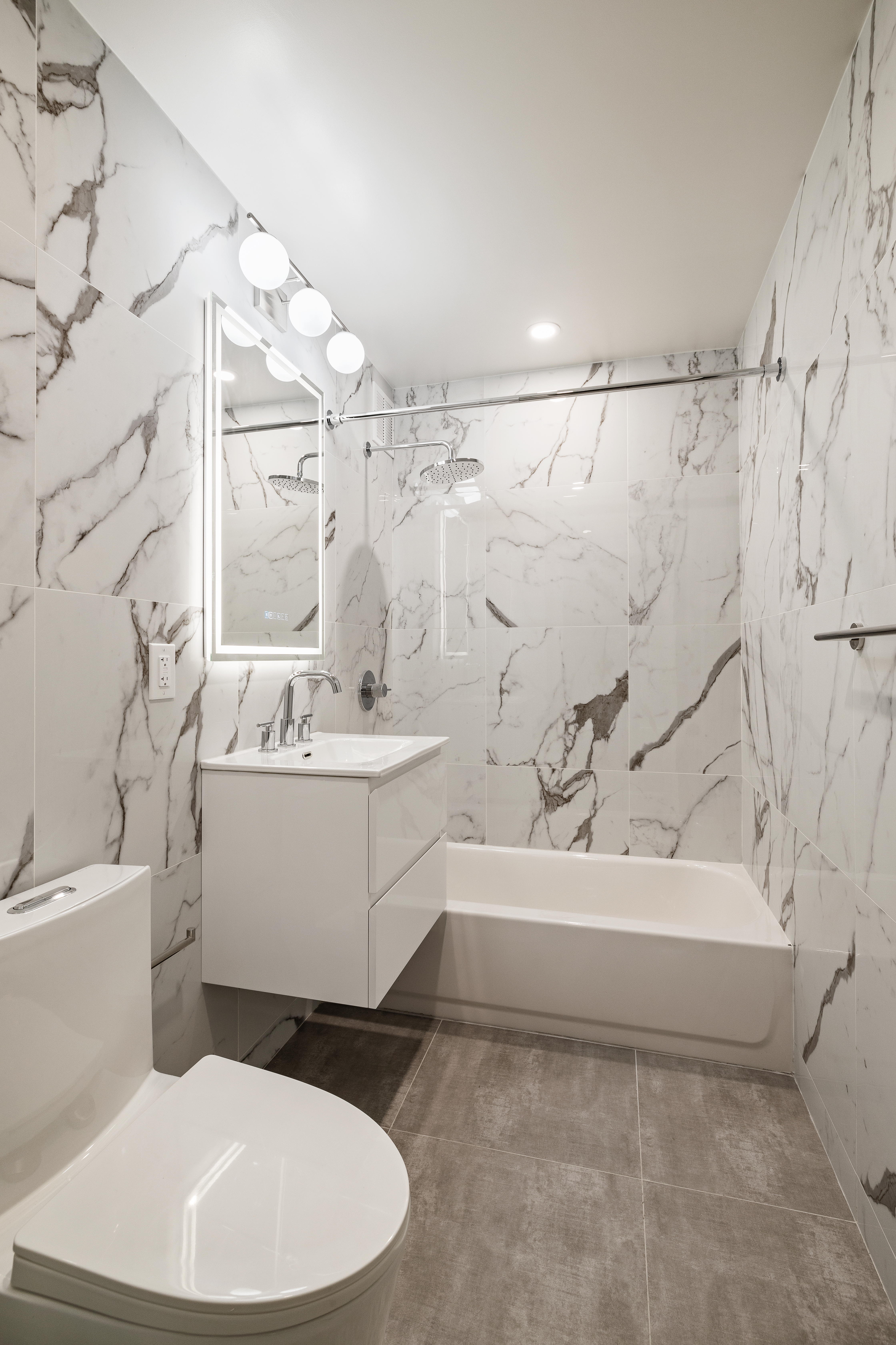 194 East 2nd Street, Unit 5L Manhattan, NY 10009 - Photo 12 of 12 a white bath tub sitting next to a white toilet