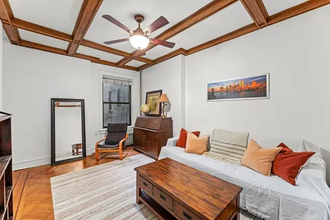 a bedroom with furniture and wooden floor