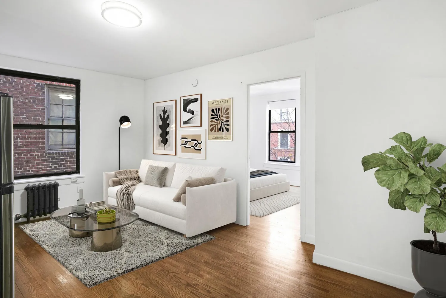 a living room with couch and wooden floor