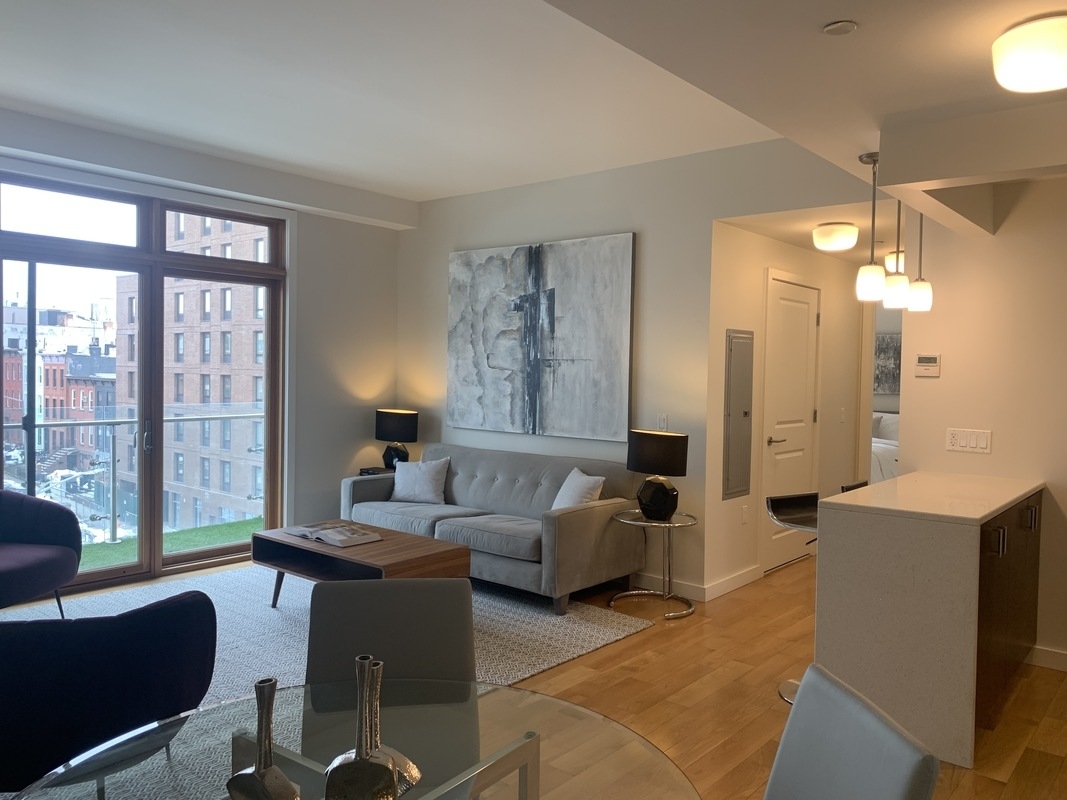 a living room with furniture and a large window