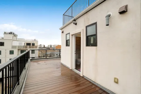 a view of a balcony with wooden floor