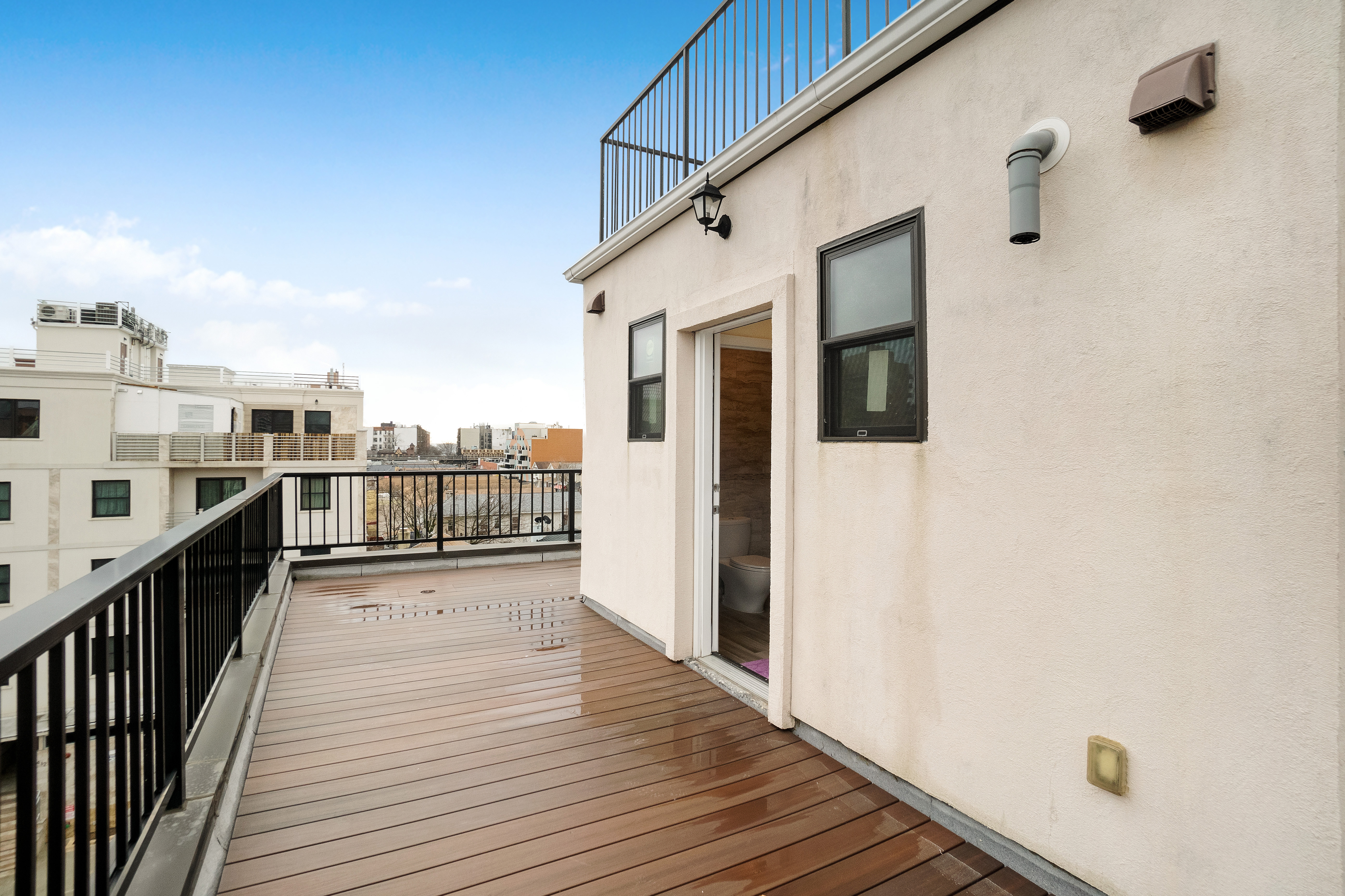 407 Oceanview Avenue, Unit PH Brooklyn, NY 11235 - Photo 10 of 16 a view of a balcony with wooden floor