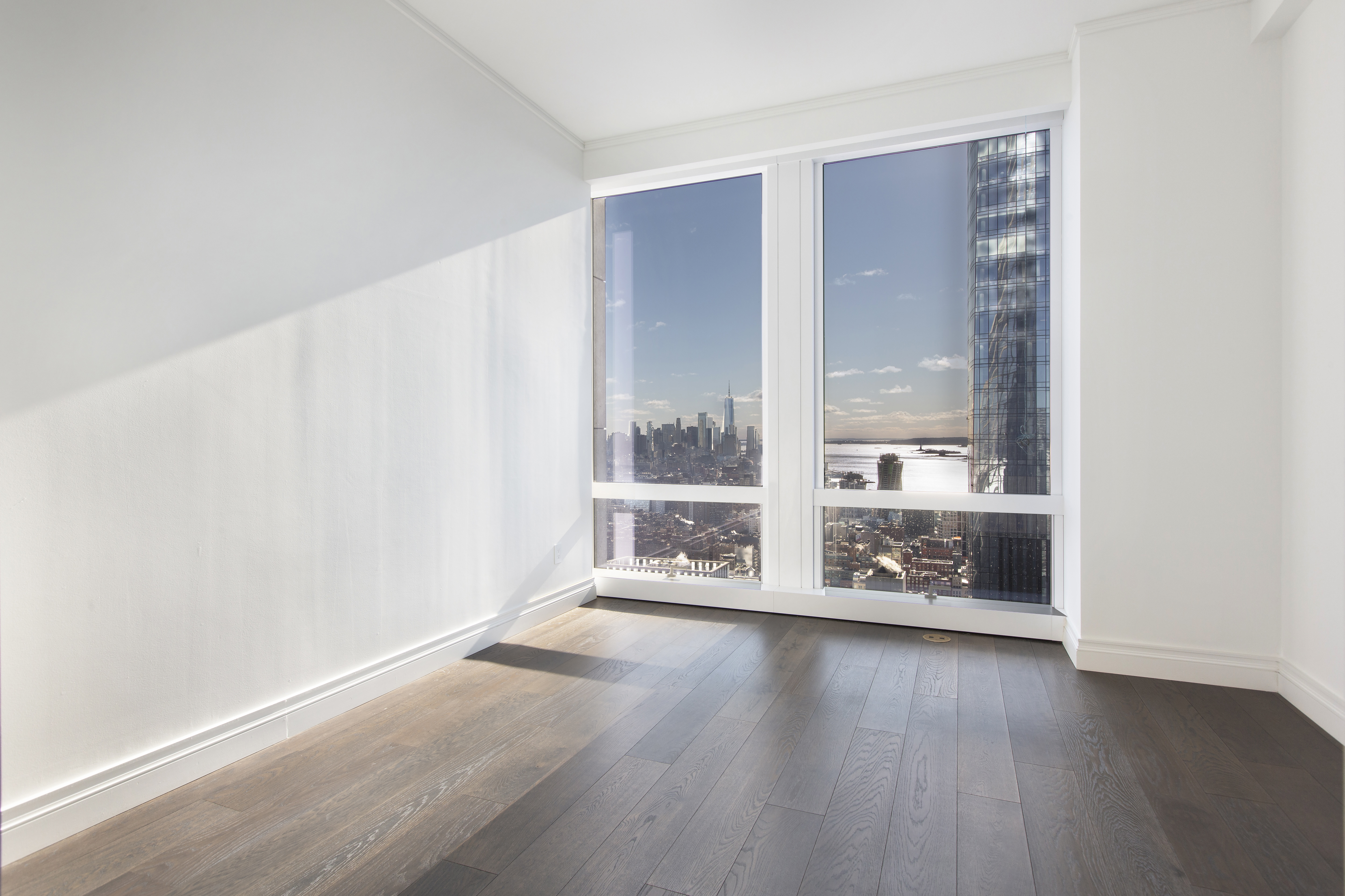 35 Hudson Yards, Unit 5805 Manhattan, NY 10001 - Photo 6 of 19 an empty room with wooden floor and windows