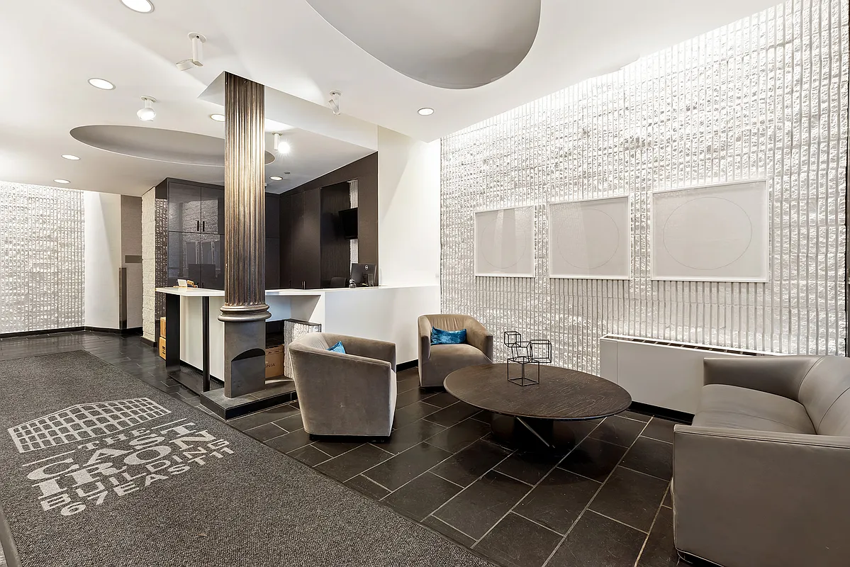 67 East 11th Street, Unit 624 Manhattan, NY 10003 - Photo 9 of 13 a living room with furniture a dining table and a fireplace