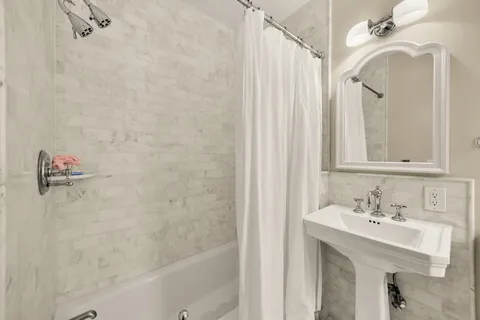 a bathroom with a sink a mirror and a shower