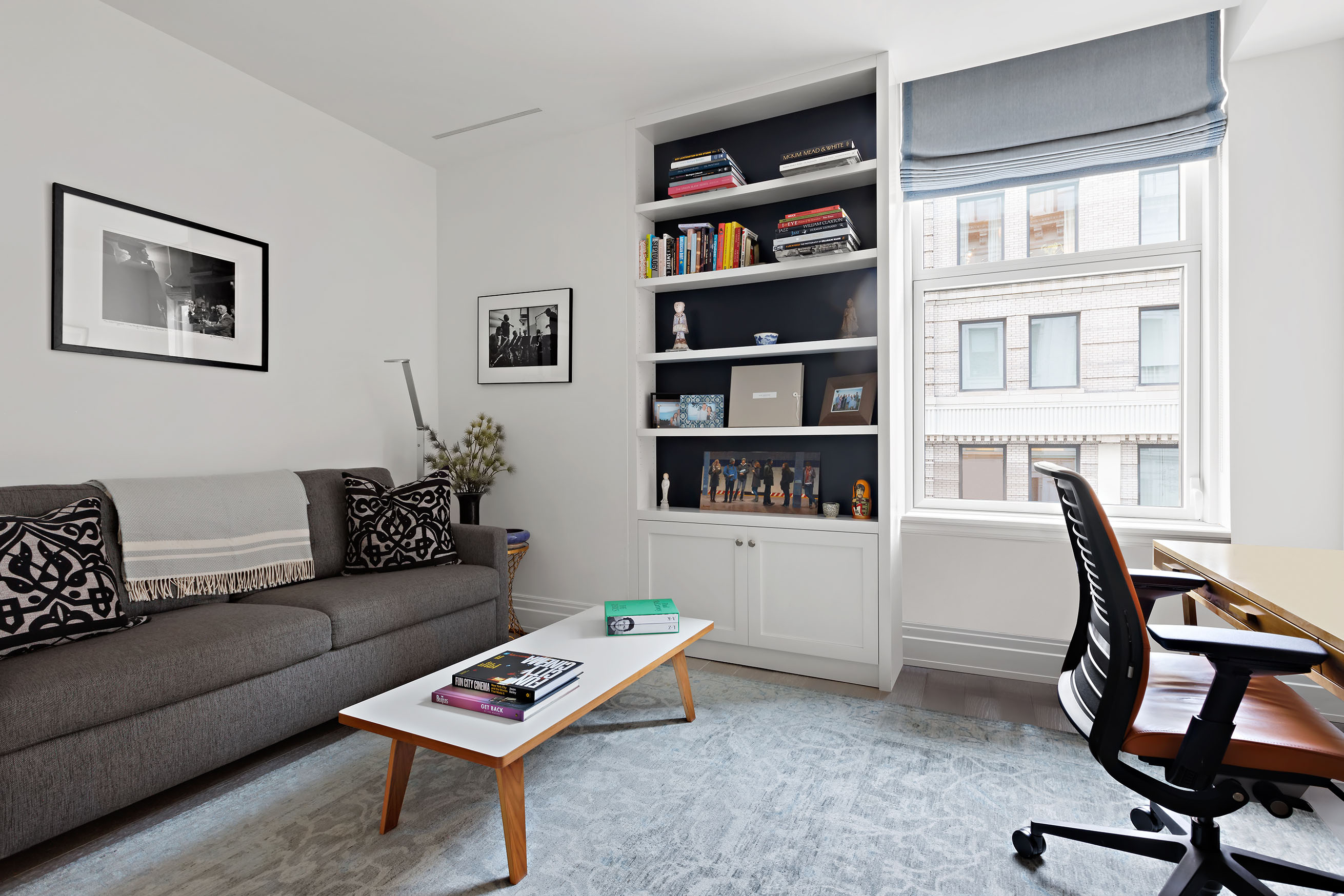 108 Leonard Street, Unit 9B Manhattan, NY 10013 - Photo 11 of 13 a living room with furniture and a bookshelf