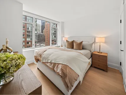 a bedroom with two beds and a large window