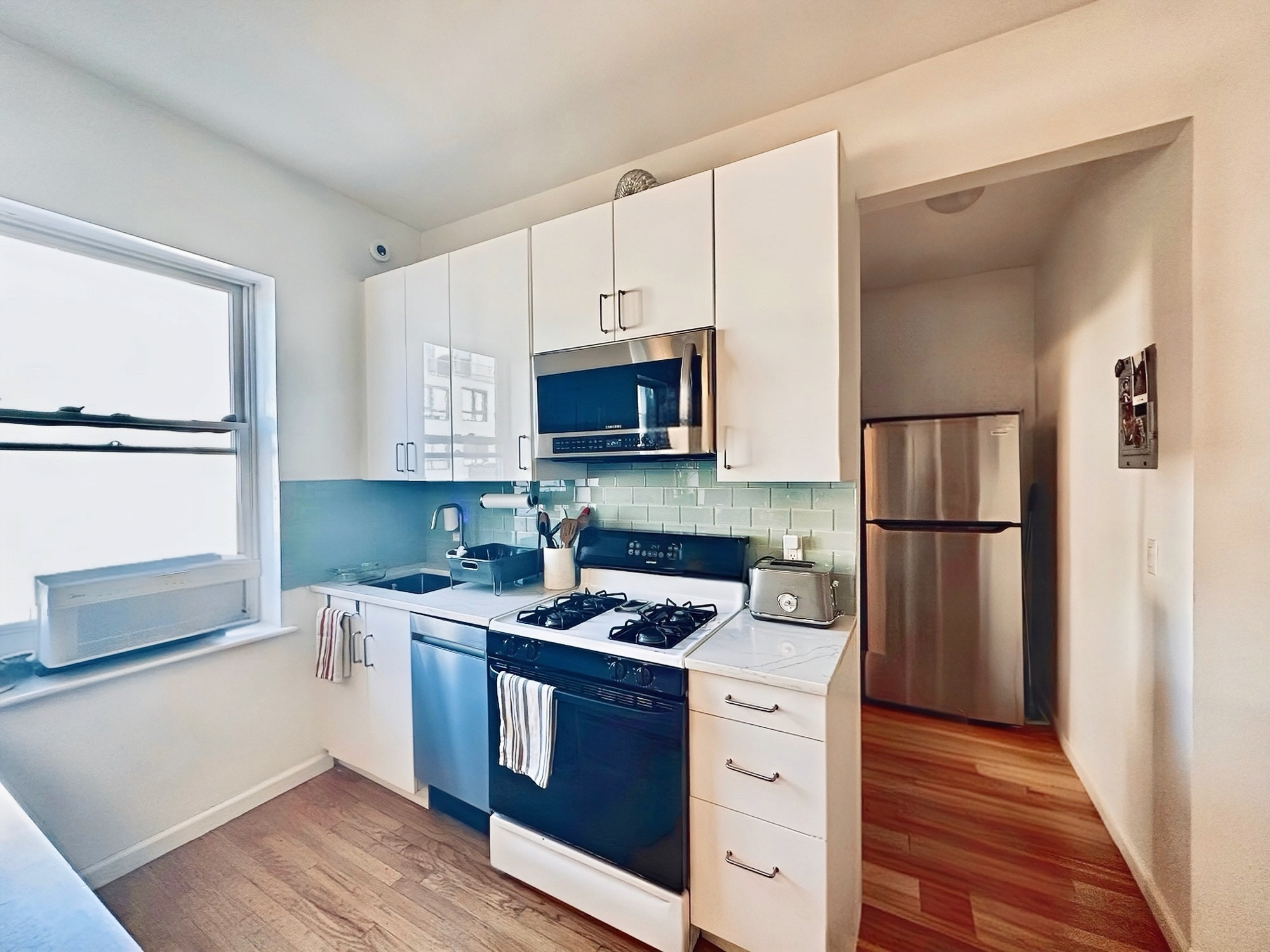 75 Warren Street, Unit 4 Brooklyn, NY 11201 - Photo 4 of 11 a kitchen with a refrigerator stove and microwave