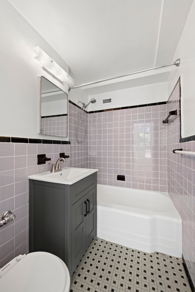 225 East 46th Street, Unit 2G Manhattan, NY 10017 - Photo 5 of 6 a bathroom with a sink toilet and shower