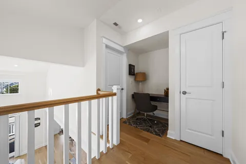 a living room with furniture large window and wooden floor
