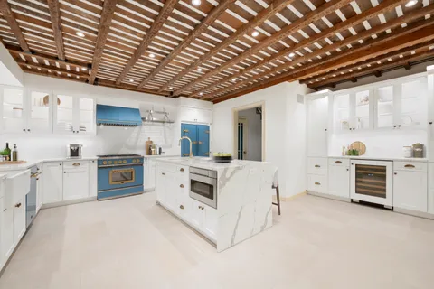 a kitchen with furniture and a stove