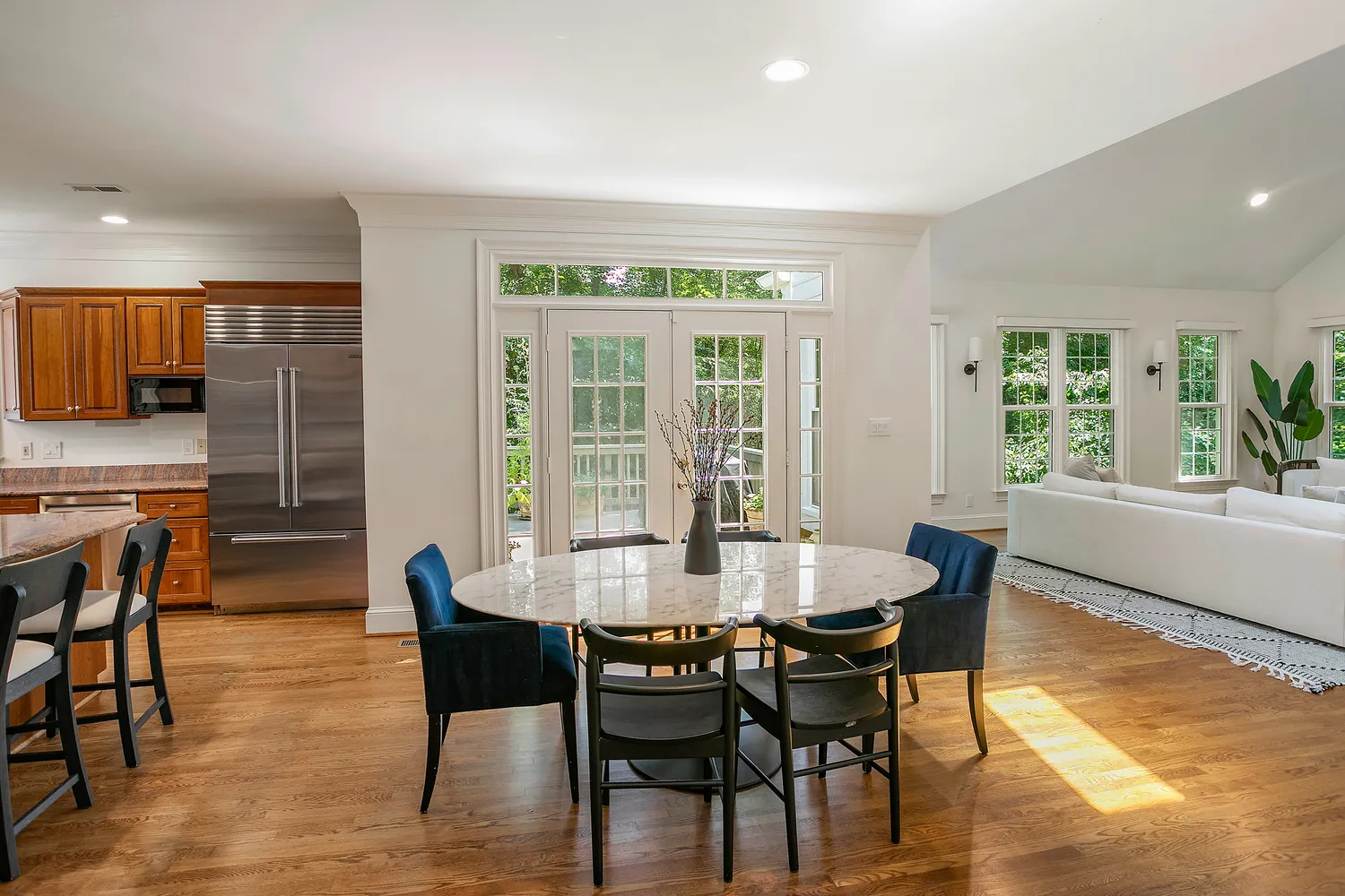 a dining room with furniture and wooden floor